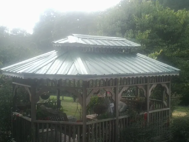 Two tier green metal roof on a garden gazebo in Prairieburg