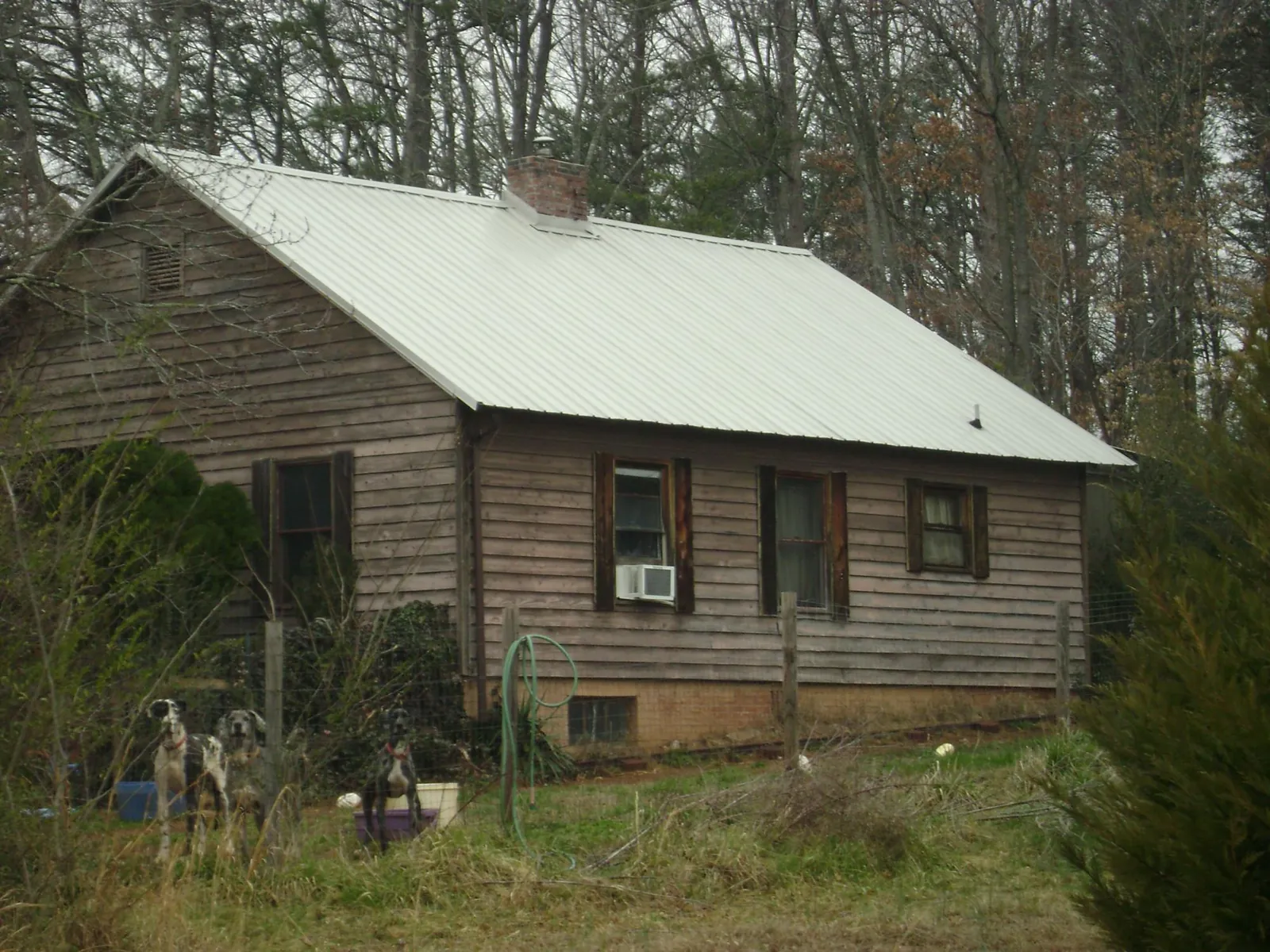 White metal roof on an old wood sided farmhouse, from a Metal Roof Installation job in Prairieburg